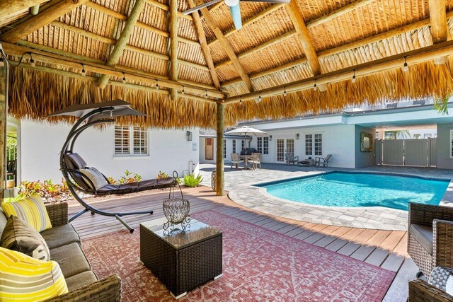 outdoor pool with a patio area, outdoor lounge area, and a gazebo