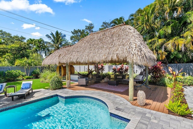 view of pool with a fenced in pool, a gazebo, an outdoor hangout area, a deck, and a fenced backyard