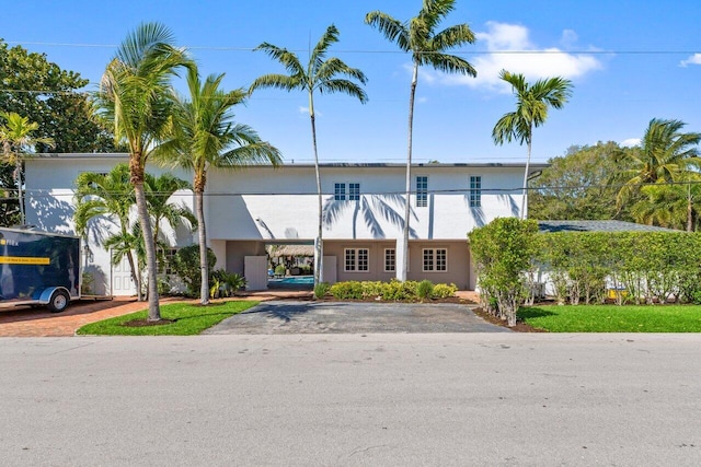 view of building exterior with a carport and aphalt driveway