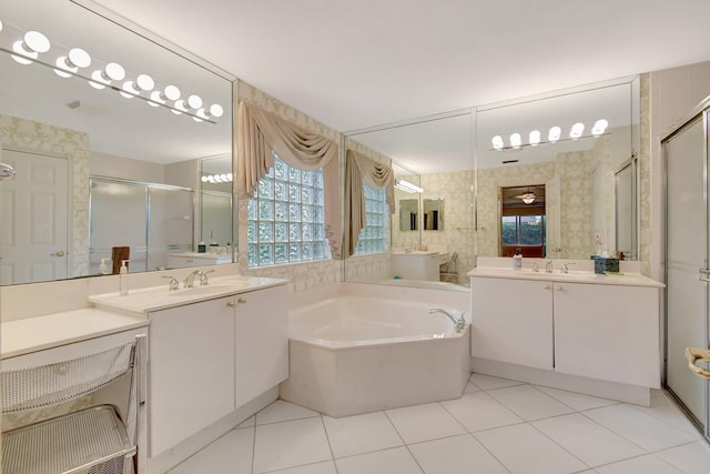 bathroom featuring a shower stall, a bath, tile patterned floors, and two vanities