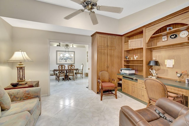 office space with built in desk and a ceiling fan