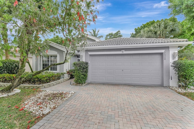garage with decorative driveway