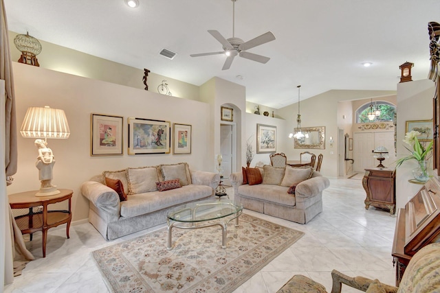 living room featuring a chandelier, vaulted ceiling, a ceiling fan, and light marble finish flooring