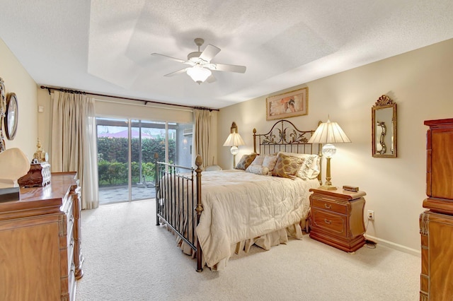 carpeted bedroom with access to exterior, a textured ceiling, ceiling fan, and baseboards