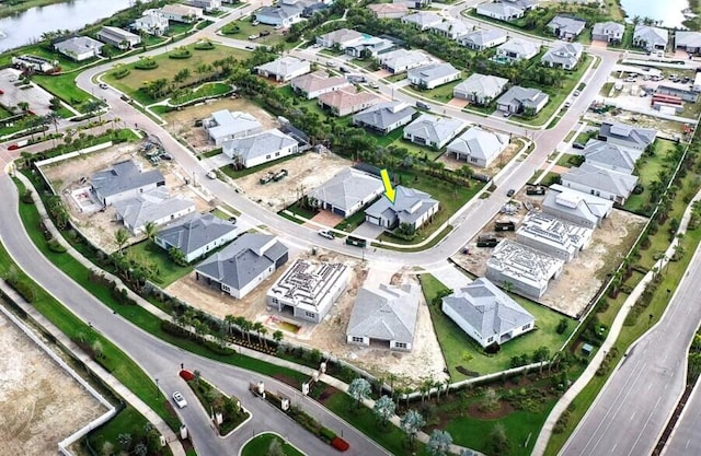 birds eye view of property with a water view and a residential view