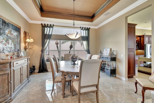 dining area featuring marble finish floor, ornamental molding, a raised ceiling, and visible vents