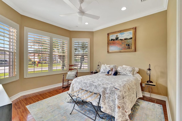 bedroom featuring ornamental molding, recessed lighting, wood finished floors, and baseboards