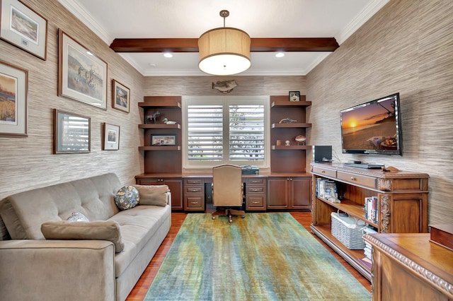 office space featuring crown molding, built in study area, wood finished floors, beamed ceiling, and wallpapered walls