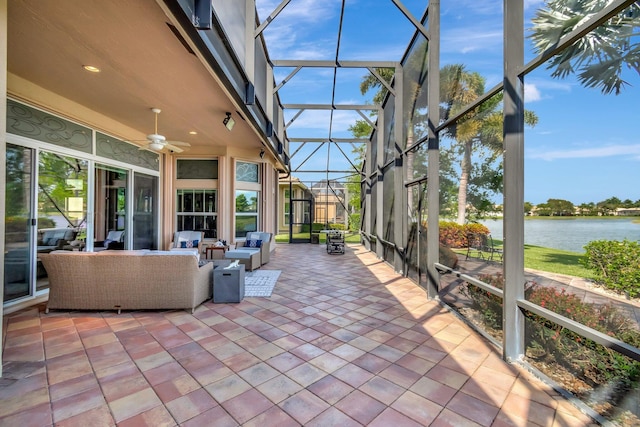 unfurnished sunroom with a water view and a ceiling fan