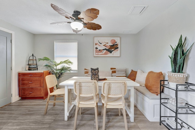 dining room featuring visible vents, breakfast area, and a ceiling fan