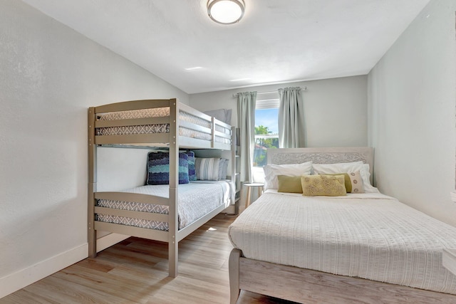 bedroom featuring baseboards and wood finished floors