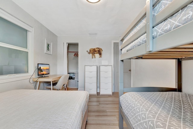 bedroom with a closet and wood finished floors