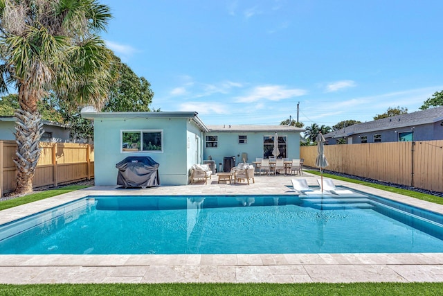 back of house with a patio area, a fenced backyard, and a fenced in pool