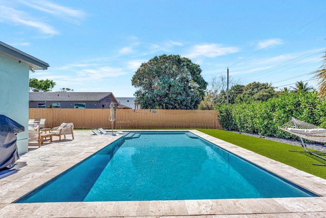 view of pool featuring a fenced backyard, a lawn, a fenced in pool, and a patio