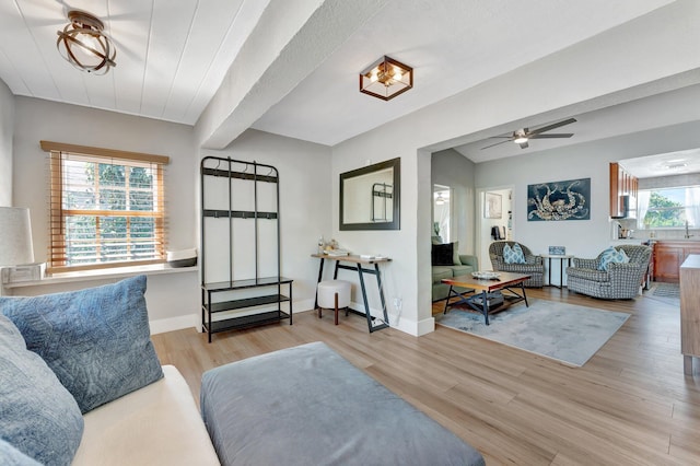 living room featuring ceiling fan, wood finished floors, and baseboards