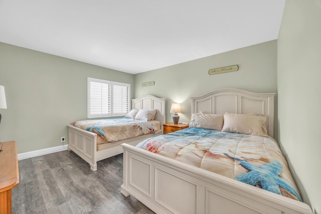 bedroom with wood finished floors and baseboards