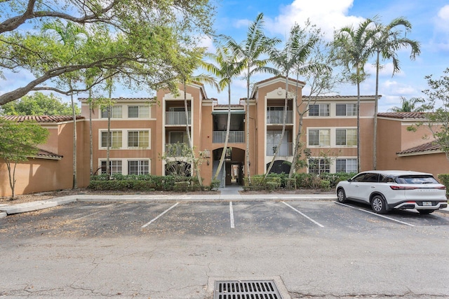 view of building exterior featuring uncovered parking