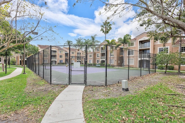 view of sport court featuring fence and a gate