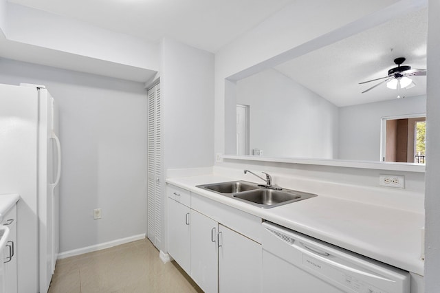 kitchen with white appliances, white cabinets, a ceiling fan, light countertops, and a sink