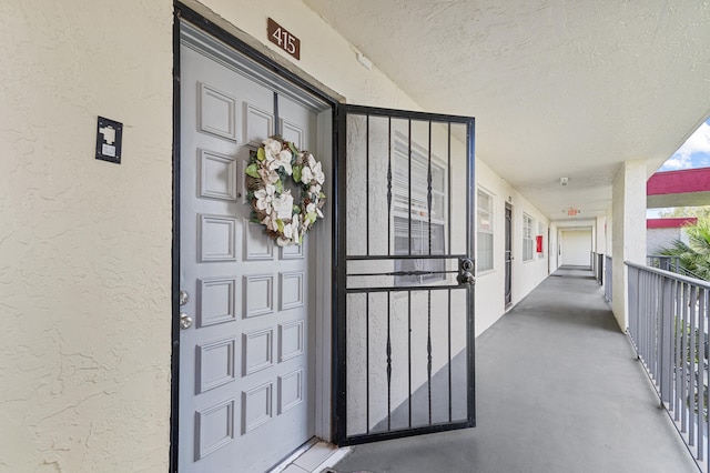 property entrance with stucco siding