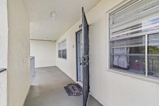 doorway to property featuring stucco siding