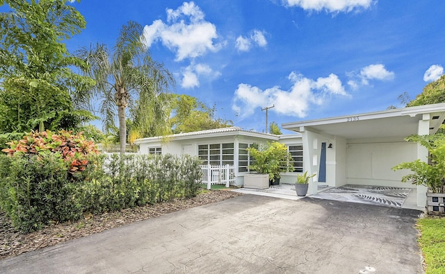 exterior space with an attached carport and driveway