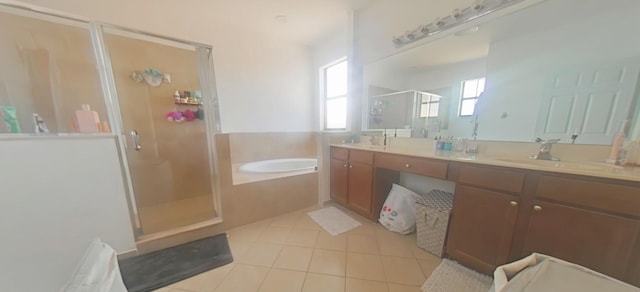 bathroom featuring double vanity, a stall shower, a sink, tile patterned flooring, and a bath