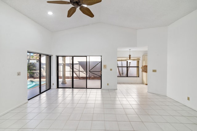 unfurnished room featuring ceiling fan, high vaulted ceiling, light tile patterned flooring, and baseboards