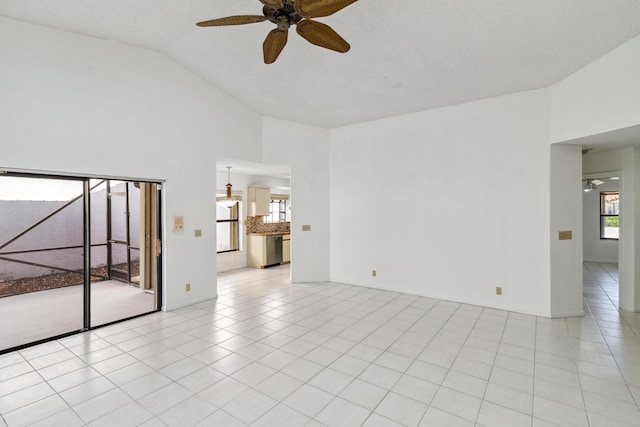 unfurnished room featuring light tile patterned floors, ceiling fan, and high vaulted ceiling