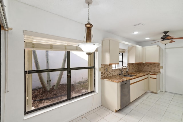 kitchen with a sink, decorative backsplash, light stone countertops, dishwasher, and pendant lighting