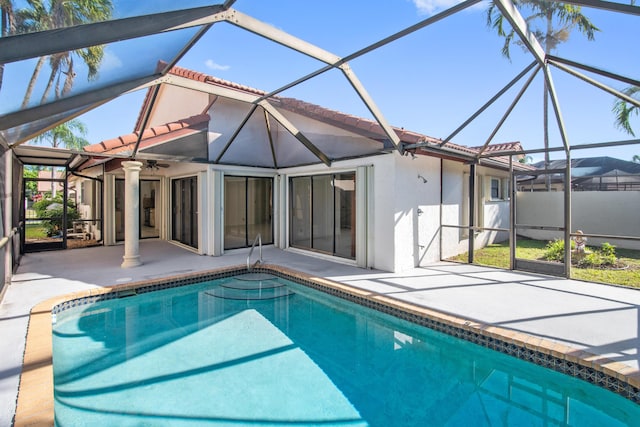 view of pool with a fenced in pool, glass enclosure, a patio area, and ceiling fan