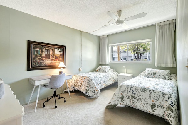 carpeted bedroom featuring a textured ceiling and a ceiling fan