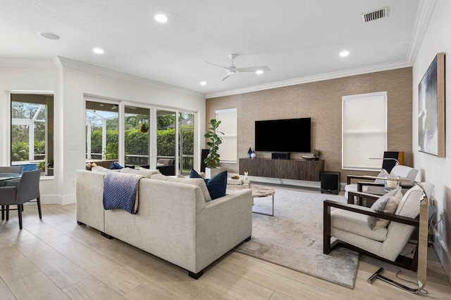 living room with visible vents, ceiling fan, crown molding, a textured ceiling, and recessed lighting