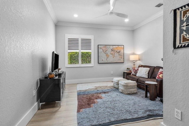 living room featuring a textured wall, wood finished floors, and crown molding