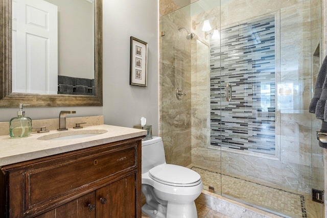 bathroom with a shower stall, toilet, and vanity