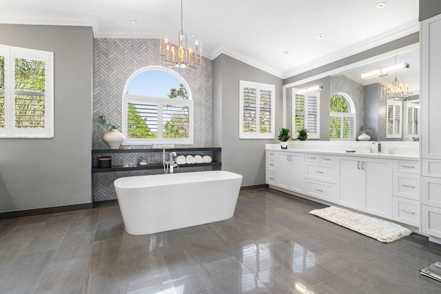 bathroom featuring a chandelier, crown molding, and plenty of natural light