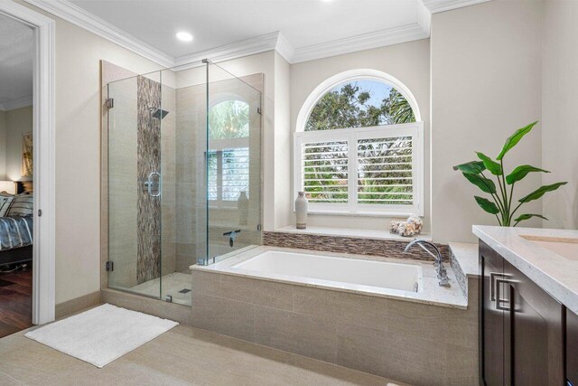 full bathroom with a garden tub, a shower stall, vanity, and crown molding