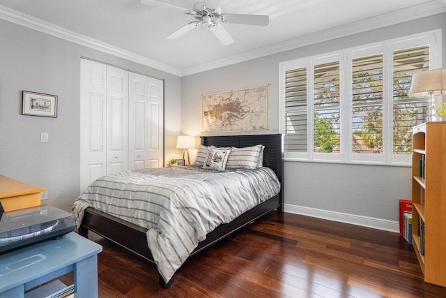 bedroom with ornamental molding, a closet, baseboards, and hardwood / wood-style flooring