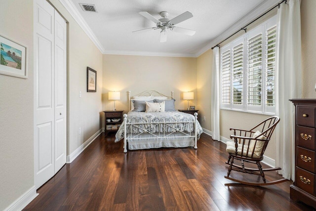 bedroom featuring ornamental molding, visible vents, baseboards, and wood finished floors