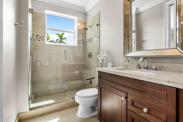 full bath with ornamental molding, a stall shower, vanity, and toilet