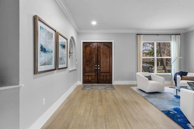 foyer entrance featuring ornamental molding, recessed lighting, baseboards, and light wood finished floors