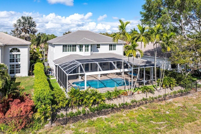 rear view of property featuring a lanai, a tile roof, an outdoor pool, and a patio