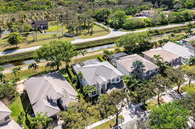 drone / aerial view with a water view and a residential view