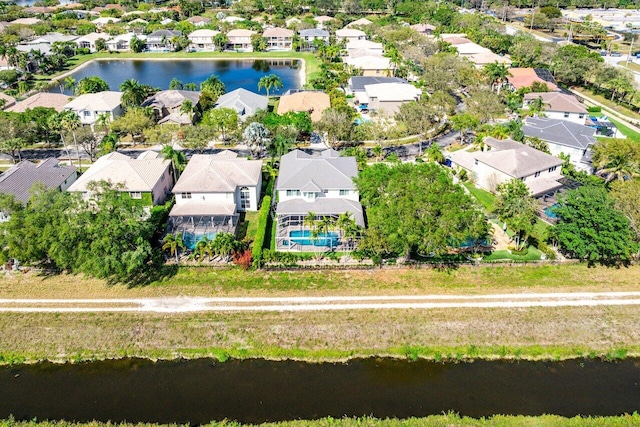 drone / aerial view with a water view and a residential view