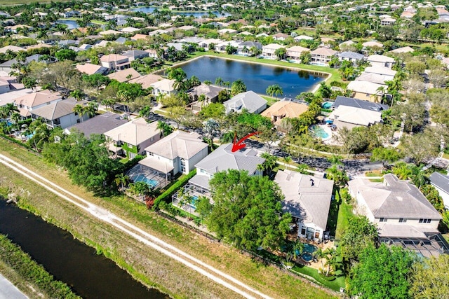 birds eye view of property with a water view and a residential view