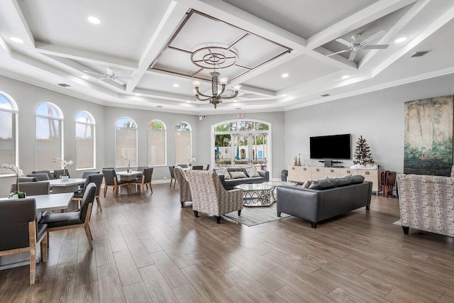 living room with dark wood-style floors, coffered ceiling, and ceiling fan with notable chandelier