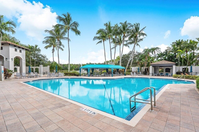 pool featuring fence, a gazebo, and a patio