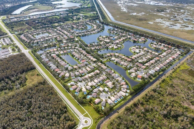 drone / aerial view with a water view and a residential view