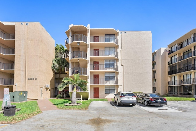 view of property featuring uncovered parking