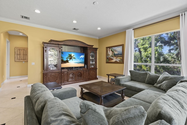 living area featuring light tile patterned floors, visible vents, arched walkways, and ornamental molding